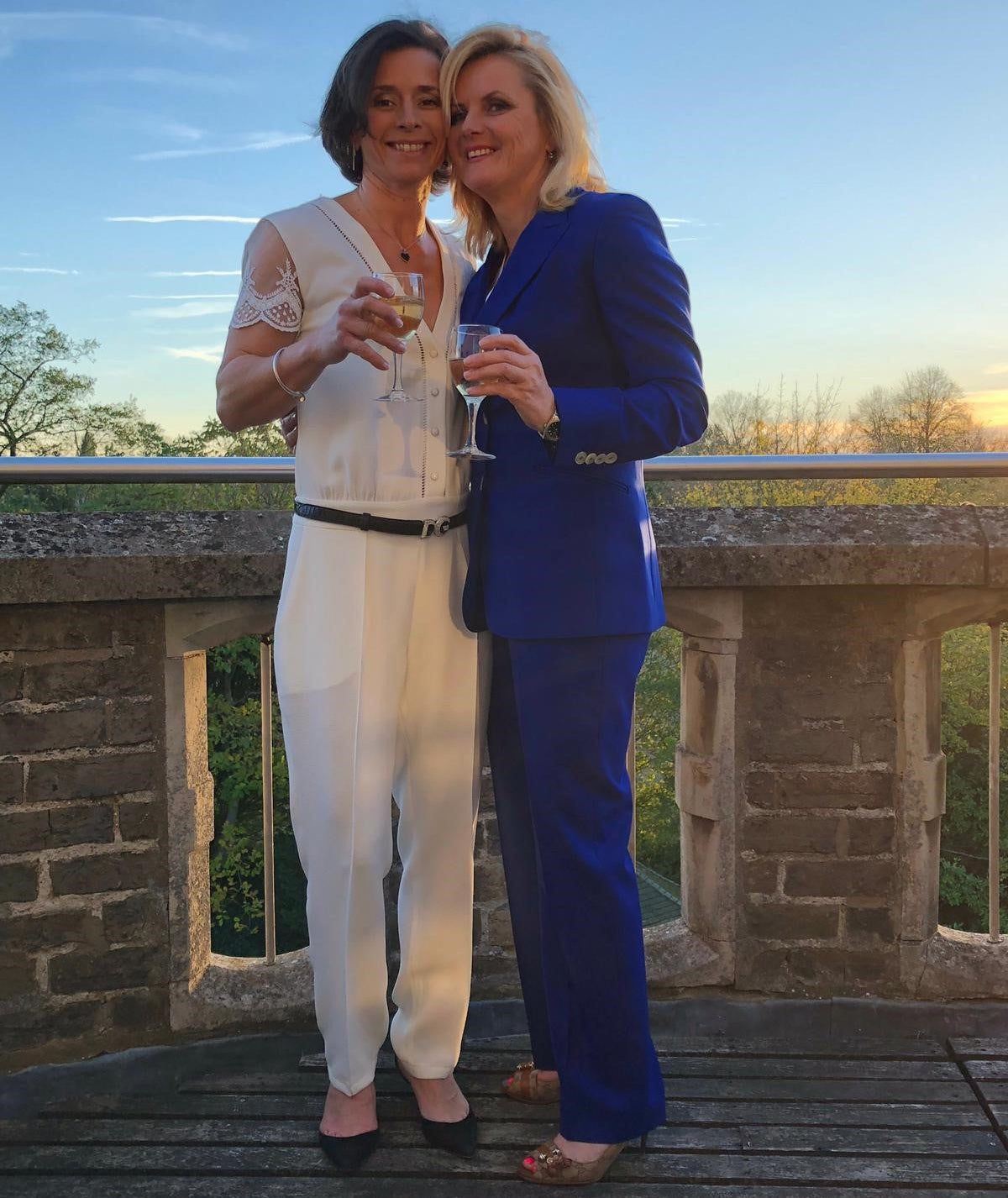 woman in wedding suit with her partner